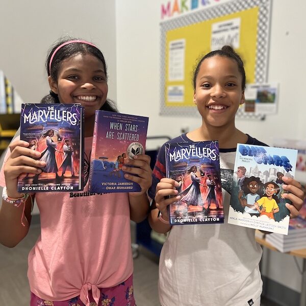 students from Talley Street Upper Elementary School posing with the books they chose at the true book fair.